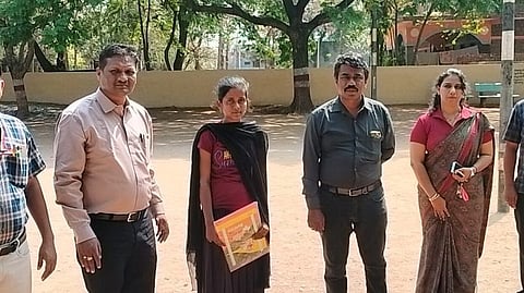 Pallavi with officials of education department at the examination centre in Mundargi town of Gadag district on Monday.