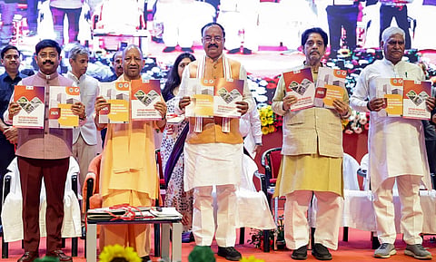 Uttar Pradesh Chief Minister Yogi Adityanath, second left, along with Deputy CM Keshav Prasad Maurya, centre, and others during the launch of the upgraded single-window investment portal 'Nivesh Mitra 3.0', in Lucknow, Tuesday, March 24, 2026. 