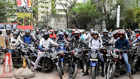 Motorists wait behind a rope for their turn to get fuel at a pump, fearing a possible fuel shortage due to the Iran war, in Dhaka, Bangladesh, Sunday, March 8, 2026. 