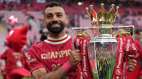 Liverpool's Mohamed Salah poses with the winner's trophy after the English Premier League soccer match between Liverpool and Crystal Palace at the Anfield stadium in Liverpool, England, May 25, 2025. 