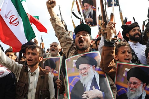 Houthi supporters hold posters of Iranian Supreme Leader Ayatollah Ali Khamenei and Iranian flags during a rally against Israel and the United States in Sanaa, Yemen, Sunday, March 1, 2026. 