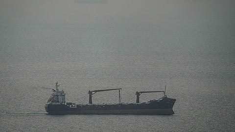 A cargo ship carrying vehicles sails through the Arabian Gulf toward the Strait of Hormuz in the United Arab Emirates, Sunday, March 22, 2026.