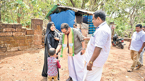 BJP candidate K Surendran interacting with a family at Bambrana 