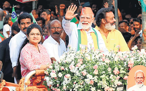 NDA candidate Padmaja Venugopal and Union Minister Suresh Gopi (right) with Prime Minister Narendra Modi during a road show held as part of the NDA’s poll campaign in Thrissur.
