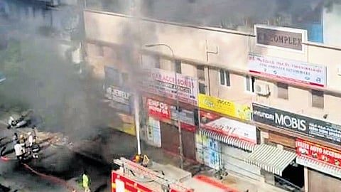 Thick black smoke from the godown that caught fire on Thursday 