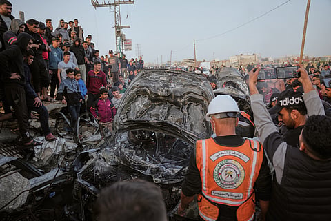 Palestinians inspect a vehicle struck by an Israeli airstrike in the Maghazi refugee camp in the central Gaza Strip, Saturday, April 4, 2026. 