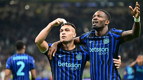 Inter Milan's Lautaro Martinez (L) celebrates scoring his team's third goal with Marcus Thuram during the Italian Serie A football match between Inter Milan and AS Roma at San Siro stadium in Milan, on April 5, 2026. 