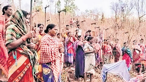 Villagers armed with traditional weapons stand guard at Sijimali on Wednesday
