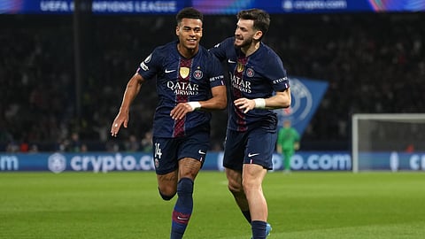 PSG's Desire Doue, left, celebrates with PSG's Khvicha Kvaratskhelia after scoring the opening goal during the Champions League quarterfinal first leg soccer match between PSG and Liverpool on April 8, 2026. 