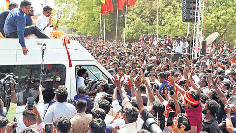 TVK chief Vijay waves to supporters at the campaign venue in Karaikudi on Friday. Fans gathered  in huge numbers along the route in Melur, SS Kottai, Tiruppathur, and Kundrakudi.