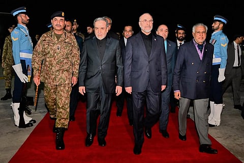 In this photo released by the Pakistan Foreign Ministry, Iran's Parliament Speaker Mohammad Bagher Qalibaf, center right, and Iran's Foreign Minister Abbas Araghchi, center left, are greeted by Pakistan Foreign Minister Ishaq Dar, right, and Army Chief Field Marshal Gen. Asim Munir, left, upon their arrival at Nur Khan airbase in Rawalpindi, Pakistan, Saturday, April 11, 2026. 