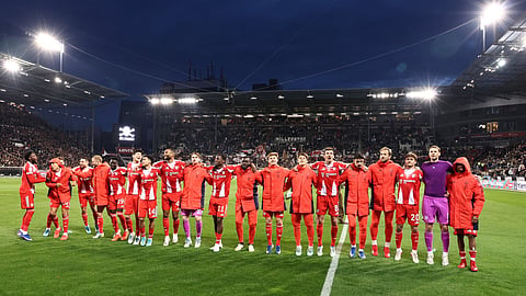 Bayern players celebrate after the German first division Bundesliga football match between FC St Pauli and FC Bayern Munich in Hamburg, northern Germany, on April 11, 2026. 