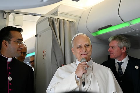 Pope Leo XIV speaks to journalists aboard his flight bound for Algiers’ Houari Boumédiène International Airport on Monday, April 13, 2026, at the start of an 11-day apostolic journey to Africa. 