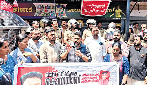 DYFI workers protest in front of the clinic linked to Dr M K Ram at Dharmadam in Kannur on Tuesday. Ram, an HoD at Kannur Dental College in Anjarakandy, was suspended following the death of first-year student Nithin Raj 