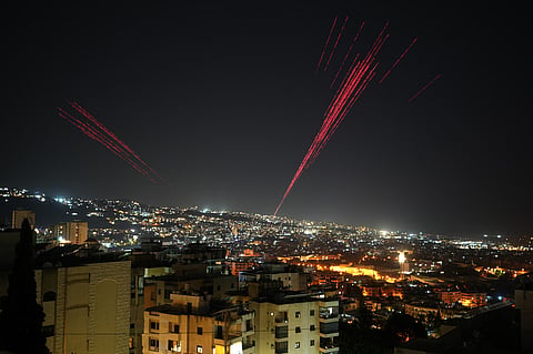 Tracer rounds illuminate the night sky as people fire live ammunition and fireworks into the air following a ceasefire between Israel and Hezbollah, in Beirut, Lebanon, early Friday, April 17, 2026. 