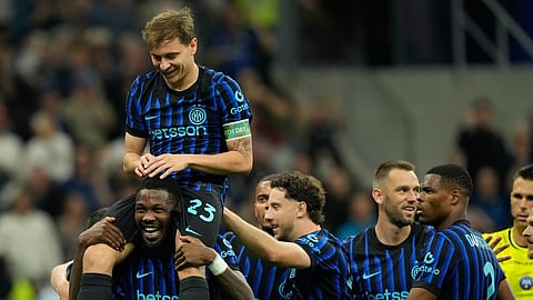 Inter Milan's Nicolo Barella, on Marcus Thuram shoulders, celebrates after scoring his side's 2nd goal during the Serie A soccer match between Inter Milan and Cagliari in Milan, Italy, Friday, April 17, 2026. 