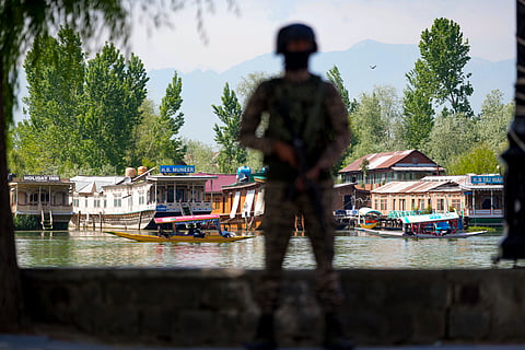  A security official keeps vigil along the Dal Lake area amid heightened security ahead of the Pahalgam attack anniversary, in Srinagar, Tuesday, April 21, 2026. 