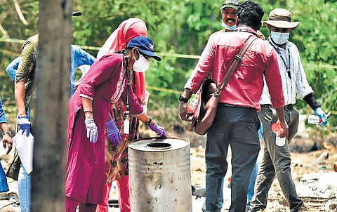 A forensic team collecting samples of the explosives from the blast site at Mundathicode in Thrissur on Wednesday.