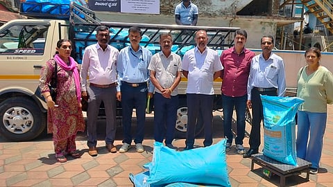 The members of Hathur PACS arrived at the Office of the JD of Agriculture in Madikeri with bags of fertilizers and a weighing scale. 