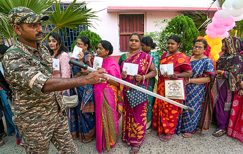 Purba Medinipur: A security personnel monitors voters during polling in the first phase of the West Bengal Assembly elections, at a polling station in Nandigram, Purba Medinipur, Thursday, April 23, 2026. 
