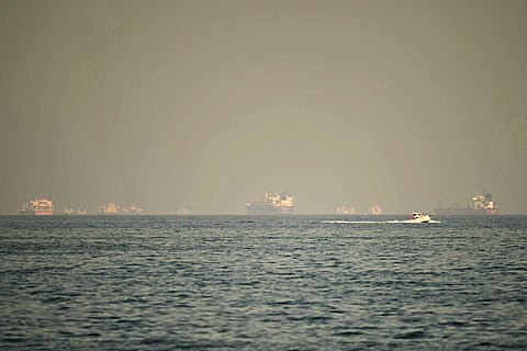 Iran's elite Revolutionary Guards said they forced two ships to the Iranian shore from the Strait of Hormuz, the narrow gateway for one-fifth of the world's oil.