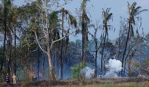 Local help the fire force personnel in dousing the fire at Mundathikode in Thrissur.