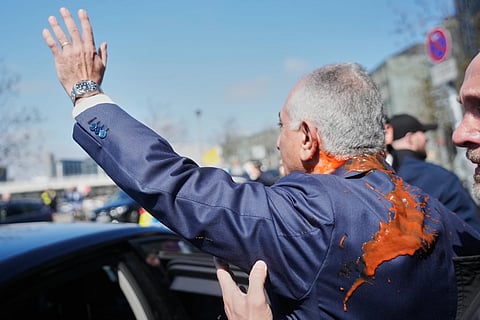Iran's Reza Pahlavi, exiled son of Shah Reza Pahlavi, waves to supporters after he was attacked with a red fluid following a news conference in Berlin, Germany, Thursday, April 23, 2026. 