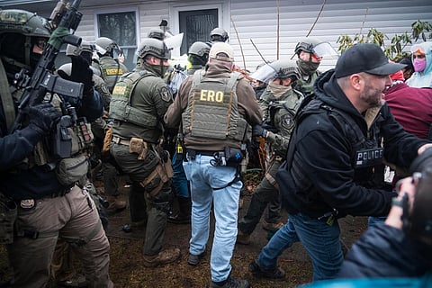 Vermont State troopers and federal law enforcement officials clash with demonstrators outside a house in South Burlington, Vt., on March 11, 2026. 