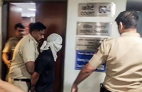 Accused Rahul Meena being produced before court in the IRS officer’s daughter murder case, in New Delhi on Thursday. 