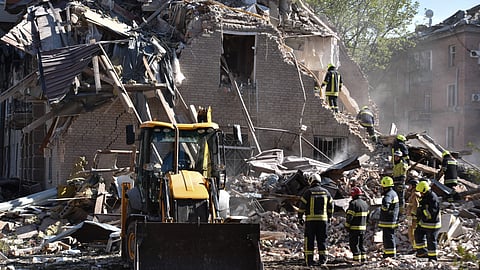 Rescue workers clear the rubble of a residential building destroyed by a Russian strike.