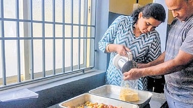 Vishwakeshava and Navyashri Kuruveri from Kasargod making cashew apple pulp 