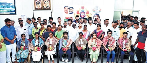 School Education and Literacy Minister Madhu Bangarappa felicitates students who secured high marks in the SSLC exam, at his office in Shivamogga on Monday. 