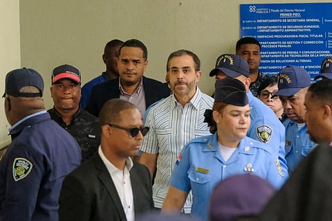 Antonio Espaillat, center, the owner of the Jet Set nightclub, whose roof collapse in 2025 resulted in fatalities, arrives at court for trial in Santo Domingo, Dominican Republic, Monday, April 27, 2026. 