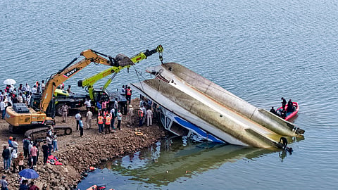 NDRF and other rescue personnel conduct an operation to recover the cruise boat, carrying 29 passengers and two crew members, that overturned in Bargi Dam due to a sudden storm, in Jabalpur district, Madhya Pradesh, Friday, May 1, 2026.