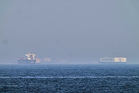 A tanker, left, and a car carrier are anchored at sea in the Gulf of Oman near the Strait of Hormuz, as seen from the coast near Khor Fakkan, United Arab Emirates, Friday, May 1, 2026.