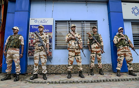 Security personnel stand guard outside a strong room, ahead of the counting of votes for the Kerala Assembly elections