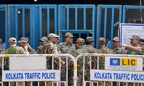Security personnel stand guard outside the strong room of Khudiram Anushilan Kendra on the eve of counting and results of the West Bengal Assembly polls, in Kolkata, West Bengal, Sunday, May 3, 2026.