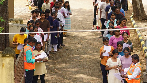 The officials are checking the hall ticket before letting students inside the NEET exam hall in Madurai.