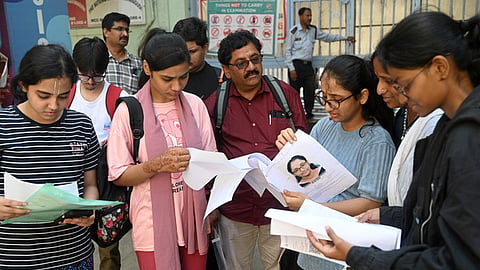Candidates at the examination centre in Bengaluru are checking documents before appearing for the NEET Exam on May 3.