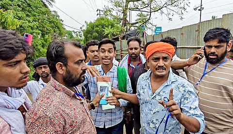 Political party representatives and officials argue outside the strong room near Asansol Engineering College after a sealed envelope allegedly containing a switched-off mobile phone was found in a vehicle linked to the Raniganj Assembly constituency, in Asansol, West Bengal, Sunday, May 3, 2026. 