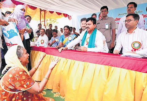 A disabled woman pleads with Revenue Minister Ponguleti Srinivasa Reddy to provide her a wheelchair during a Praja Darbar programme organised in Khammam on Thursday. The wheelchair was handed over to her within two hours