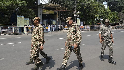 Security personnel keep vigil outside a vote-counting centre during the West Bengal Assembly election results day, in Kolkata.