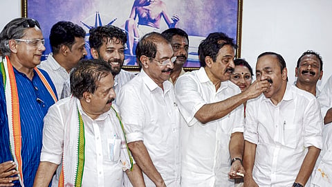 Congress MP KC Venugopal offers sweets to Leader of Opposition in Kerala Assembly and UDF candidate from Paravur constituency VD Satheesan, during vote tabulation on the day of Kerala Assembly election results, in Thiruvananthapuram, Monday, May 4, 2026. 