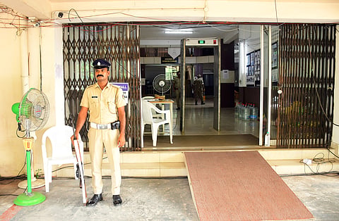 A police officer stands guard in front of the election result counting centre set up at CUSAT Engineering College, Kalamassery.