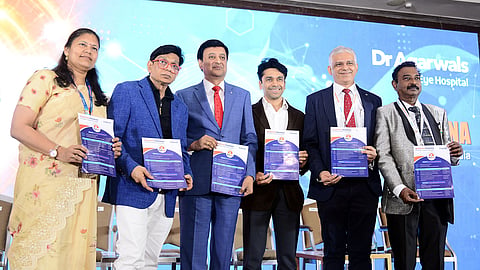 Dr Amar Agarwal (second from left) and  Dr C Sridhar (third from left) release a pamphlet during Reticon 2026.