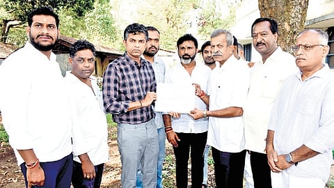 Returning officer Gaurav Kumar Shetty hands over the victor certificate to DN Jeevaraj, declaring him as the newly elected MLA in Chikkamagaluru on Monday.