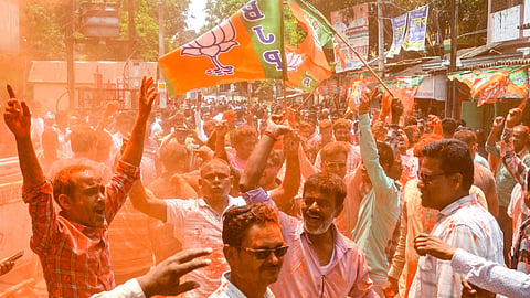 BJP supporters celebrate as the party takes lead during the West Bengal Assembly elections result day, at Balurghat, in Dakshin Dinajpur district, Monday, May 4, 2026.