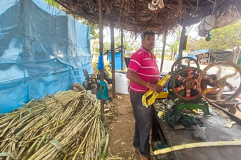 Hearing-impaired vendor Venkateswararao preparing and selling sugarcane juice near JMJ College on the Jangareddygudem highway outskirts of Eluru. 