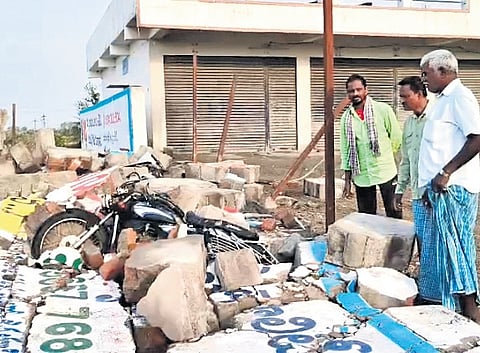 Locals clear the debris from the destruction caused the late-night rains at the Kothur paddy procurement centre in Mancherial district on Wednesday