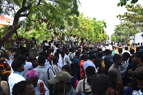 TVK party cadres crowded outside their party headquarters in at Panaiyur on Tuesday.